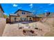 Backyard includes a patio with brick accents, seating, and a view of the home's exterior at 112 Austin Rose Ave, Henderson, NV 89002