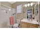 Bathroom features a glass-enclosed shower, vanity with sink, and a large mirror at 112 Austin Rose Ave, Henderson, NV 89002
