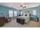 Comfortable bedroom with neutral carpet, a ceiling fan, and a window with white shutters at 112 Austin Rose Ave, Henderson, NV 89002