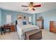 This bedroom has a ceiling fan and light-blue walls, which provide a relaxing ambiance at 112 Austin Rose Ave, Henderson, NV 89002