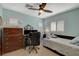 Well-lit bedroom with window, ceiling fan, and desk provides a comfortable and functional living space at 112 Austin Rose Ave, Henderson, NV 89002