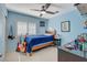 Cozy bedroom features a ceiling fan, light-blue walls, and a window with white blinds at 112 Austin Rose Ave, Henderson, NV 89002
