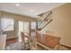 Bright dining area with wood floors leading to a sliding glass door and carpeted stairs at 112 Austin Rose Ave, Henderson, NV 89002