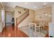 Cozy dining room featuring hardwood floors, a wooden table, and adjacent stairway at 112 Austin Rose Ave, Henderson, NV 89002