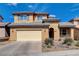 Charming two-story home with a well-manicured yard, two-car garage, and welcoming front porch beneath blue skies at 112 Austin Rose Ave, Henderson, NV 89002