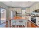 Modern kitchen with white cabinets, stainless steel appliances, and a large center island at 112 Austin Rose Ave, Henderson, NV 89002