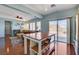 Open-concept living space with hardwood floors, ceiling fan, and sliding glass doors to the backyard at 112 Austin Rose Ave, Henderson, NV 89002