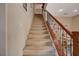 Carpeted staircase with wood railing leading to the upper level of the home at 112 Austin Rose Ave, Henderson, NV 89002