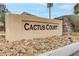 Stone-laden Cactus Court sign surrounded by low-maintenance desert landscaping and shrubbery at 1150 Red Margin Ct # 101, Las Vegas, NV 89183