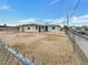 Exterior view of single story home with a large backyard with chain link fence at 1200 Cunningham Dr, Las Vegas, NV 89106