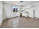 Bright kitchen featuring white cabinets, tile flooring, and a window with a neighborhood view at 1200 Cunningham Dr, Las Vegas, NV 89106