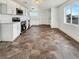 Modern kitchen featuring stainless steel appliances, white cabinetry, and durable tile flooring at 1200 Cunningham Dr, Las Vegas, NV 89106