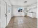 Bright kitchen featuring white cabinets, tile flooring, and a window with a neighborhood view at 1200 Cunningham Dr, Las Vegas, NV 89106