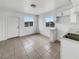 Bright kitchen featuring white cabinets, tile flooring, and a window with a neighborhood view at 1200 Cunningham Dr, Las Vegas, NV 89106
