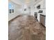 Modern kitchen with stainless steel appliances, white cabinets, and durable floors open to the living room at 1200 Cunningham Dr, Las Vegas, NV 89106
