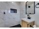 Modern bathroom featuring marble tile shower, contemporary vanity and black accents at 1203 Tamerack Ave, Las Vegas, NV 89106