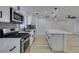 Well-lit kitchen features stainless steel appliances, gray backsplash, and white cabinets at 1203 Tamerack Ave, Las Vegas, NV 89106