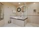 Bathroom featuring a soaking tub and a glass enclosed shower at 125 E Harmon Ave # 2205, Las Vegas, NV 89109