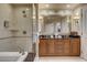 Bathroom featuring a glass-enclosed shower, soaking tub, and double sink vanity at 125 E Harmon Ave # 2205, Las Vegas, NV 89109
