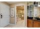 Elegant bathroom featuring a soaking tub, glass shower, and stylish vanity with mirrored accents at 125 E Harmon Ave # 2205, Las Vegas, NV 89109