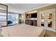 Comfortable hotel bedroom with kitchenette, accent chair, and views of the city at 125 E Harmon Ave # 2205, Las Vegas, NV 89109