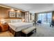 Comfortable bedroom with large bed, a lounge, and sliding glass doors to balcony at 125 E Harmon Ave # 2205, Las Vegas, NV 89109