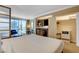Bright hotel bedroom with kitchenette, closet, and views of the city at 125 E Harmon Ave # 2205, Las Vegas, NV 89109