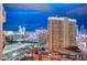 Expansive city view at twilight, capturing the illuminated buildings and urban landscape at 125 E Harmon Ave # 2205, Las Vegas, NV 89109