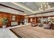 Elegant lobby featuring wood paneling, stylish furniture, and a chandelier at 125 E Harmon Ave # 2205, Las Vegas, NV 89109