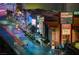 Vibrant street view featuring Planet Hollywood, Miracle Mile Shops, and palm trees illuminated with colorful lights at 125 E Harmon Ave # 2205, Las Vegas, NV 89109