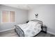 Bright bedroom with a metal frame bed, white and blue patterned bedding, and a large window at 1252 Autumn Wind Way, Henderson, NV 89052