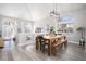 Well-lit dining room with a wooden table, bench seating, and large windows at 1252 Autumn Wind Way, Henderson, NV 89052