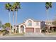 Beautiful two-story home featuring a well-manicured lawn and tall palm trees at 1252 Autumn Wind Way, Henderson, NV 89052