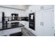 Charming kitchen features white cabinets, granite countertops, and stainless steel appliances at 1252 Autumn Wind Way, Henderson, NV 89052