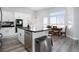 Modern kitchen with stainless steel appliances, a large island, and bright, airy breakfast nook at 1252 Autumn Wind Way, Henderson, NV 89052