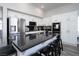 Well-appointed kitchen with a spacious island, black countertops, and stainless steel appliances at 1252 Autumn Wind Way, Henderson, NV 89052