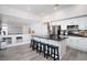 Modern kitchen with white cabinets, stainless steel appliances, and a center island with bar stool seating at 1252 Autumn Wind Way, Henderson, NV 89052