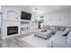 Cozy living room with a fireplace, large TV, and a comfortable sectional sofa with a view to the windows at 1252 Autumn Wind Way, Henderson, NV 89052