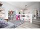 Spacious living room featuring high ceilings, white shelving, and hardwood flooring at 1252 Autumn Wind Way, Henderson, NV 89052