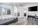 Bright main bedroom boasts a fireplace, wood floors, and an ensuite bathroom with a tub and shower at 1252 Autumn Wind Way, Henderson, NV 89052