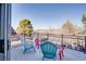 The patio features colorful chairs and a view of trees, homes, and the mountains in the distance at 1252 Autumn Wind Way, Henderson, NV 89052