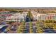 Aerial view of a vibrant shopping area with colorful buildings and palm-lined streets against a mountain backdrop at 2020 Rainbow View St, Henderson, NV 89012