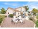Well-maintained backyard featuring a fire pit, patio furniture, barbecue, and second story balcony at 2020 Rainbow View St, Henderson, NV 89012