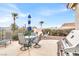 Backyard patio with furniture, grill, and palm trees, ideal for outdoor dining and relaxation at 2020 Rainbow View St, Henderson, NV 89012