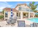 Inviting backyard with patio seating, grill, pool, and a second-story balcony for outdoor enjoyment at 2020 Rainbow View St, Henderson, NV 89012