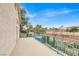 This balcony has green bars overlooking trees and shrubbery at 2020 Rainbow View St, Henderson, NV 89012