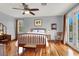 Bright bedroom with hardwood floors, ceiling fan, and a balcony at 2020 Rainbow View St, Henderson, NV 89012