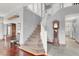 Grand two-story foyer with a staircase, hardwood floors, and natural light at 2020 Rainbow View St, Henderson, NV 89012
