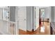 Bright hallway with wood floors, neutral walls, and white trim, offering a transition to other rooms in the home at 2020 Rainbow View St, Henderson, NV 89012
