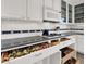 Kitchen with black countertop, custom spice rack and stainless steel appliances at 2020 Rainbow View St, Henderson, NV 89012